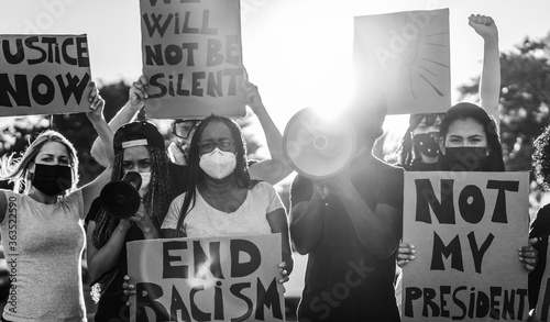 Photography People from different ages and races protest on the street for no racism equal r