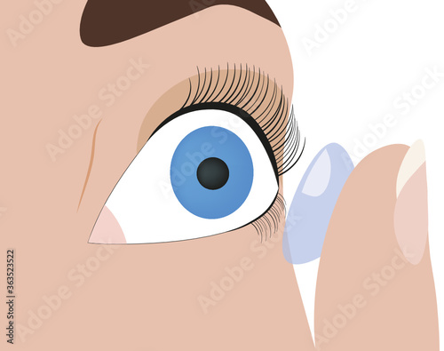 Person holding a contact lens on a finger