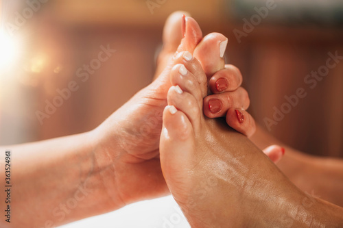 Reflexology Foot Massage. Reflexologist Applying Pressure to client’s Big Toe