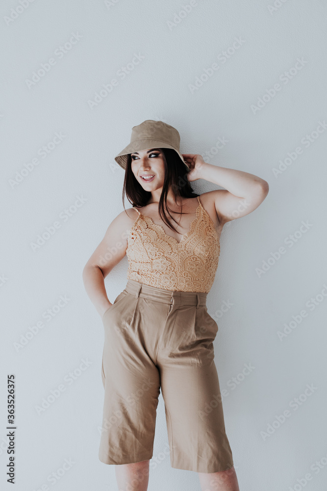 Beautiful asian woman brunette in beige fashionable clothes with hat Beautiful asian woman brunette in beige fashionable clothes with hat