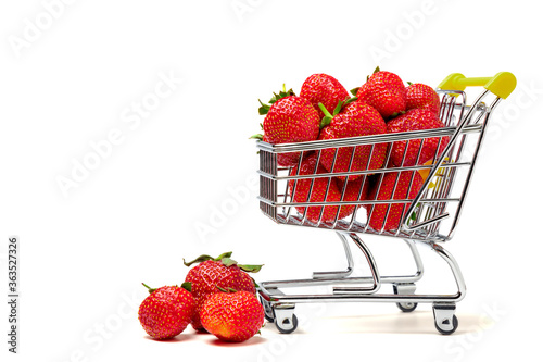 Strawberry. Sweet organic fragrant strawberries in a mini-cart for shopping isolated on a white background.