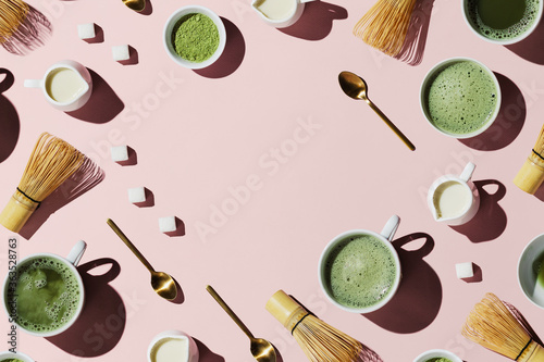 Flat lay of tools for making and cups of vegan matcha latte with oat milk photo