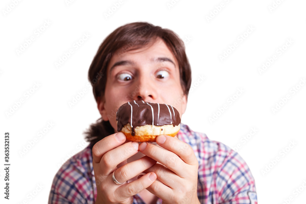 Funny man looks at the chocolate doughnut bulging eyes, a very funny photo on a white background. Empty space for text. A man loves sweets chocolate. World Chocolate Day stock images Funny man looks at the chocolate doughnut bulging eyes, a very funny photo on a white background. Empty space for text. A man loves sweets chocolate. World Chocolate Day stock images