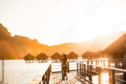 Beautiful girl posing on dock on sunset. tropical resort