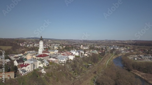 Biecz, Poland - 3 9 2019: Panorama of the historic center of the European medieval city on the picturesque green hills. Trips to architectural monuments: temples, central square, town hall, municipal
