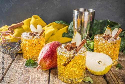 Pear cider cocktail with spices . Traditional fall and winter cold beverage photo