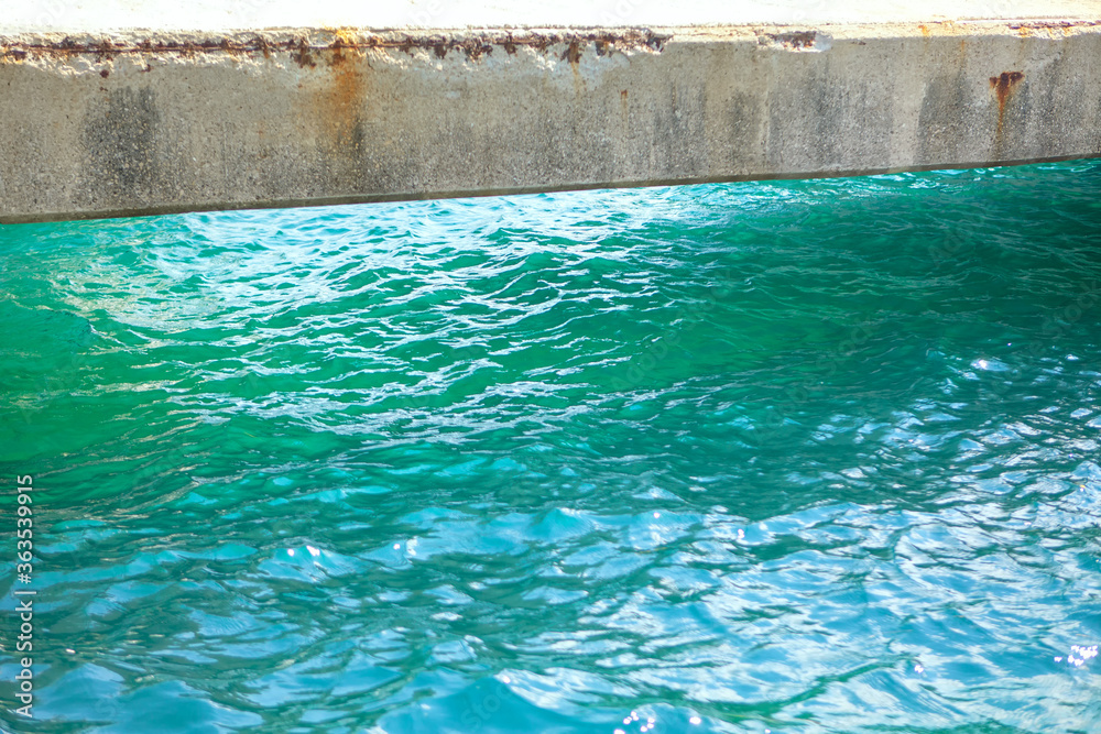 Concrete beam bridge over water . Turquoise Colored Sea Water 