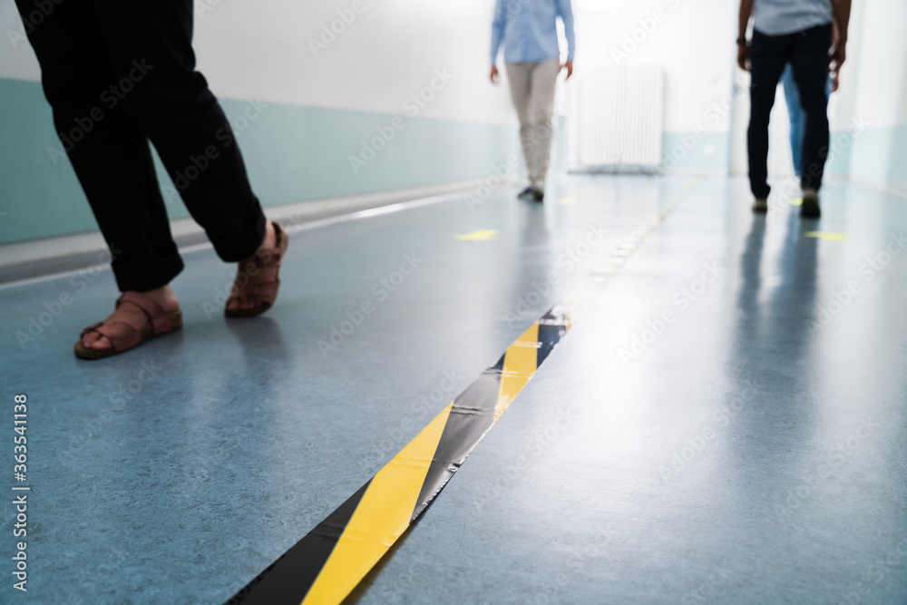 People In Office Following Social Distancing Tape Markings People In Office Following Social Distancing Tape Markings