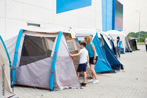 Mom and son camping tent in shop