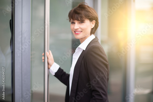 portrait of a woman working in an office posing in front of her business