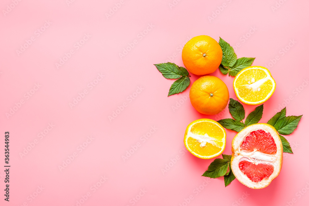 Oranges and grapefruits with leaves on table top view copy space Oranges and grapefruits with leaves on table top view copy space