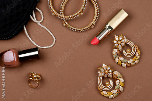 Pearl Jewelry on a brown background, lipstick, Pearl bracelet,nail polish,pearl necklace, pearl earrings,finger ring.Style, fashion and design of jewelry. indian traditional jewellery,backgroud