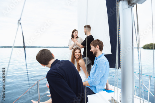 Canvas Print Group of happy friends drinking vodka cocktails at boat party outdoor, cheerful and happy
