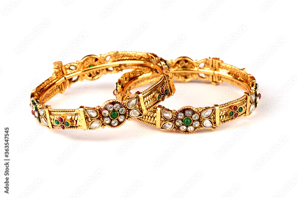 Indian golden Bangles. Bracelet with diamonds and stones on a white background, Indian Traditional Jewellery,Style, fashion and design of jewelry Indian golden Bangles. Bracelet with diamonds and stones on a white background, Indian Traditional Jewellery,Style, fashion and design of jewelry