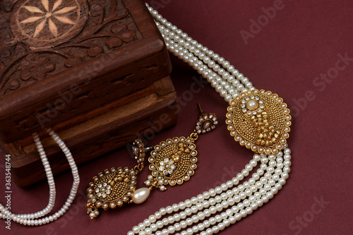 Vintage wooden jewellery box with Indian traditional jewelry, pearl earrings, pearl bracelet Luxury female jewelry, Indian traditional jewellery,Bridal Gold wedding jewellery, pearl jewelry