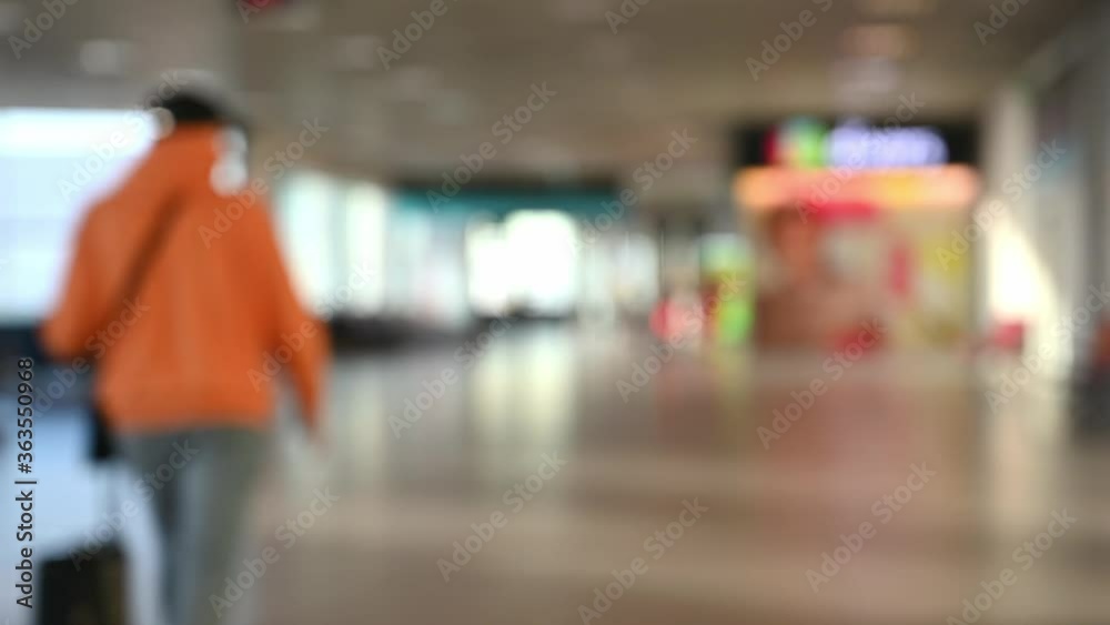 Blurred people walk at departure terminal in Lisbon airport Blurred people walk at departure terminal in Lisbon airport