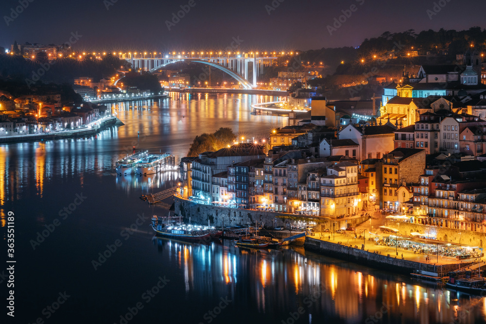 Night city skyline of Porto from Luis I bridge over Douro river, Portugal