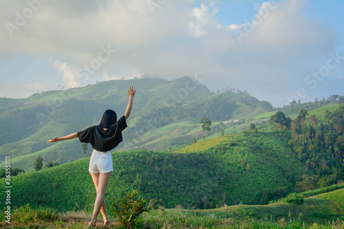 young woman doing yoga exercises in the mountains