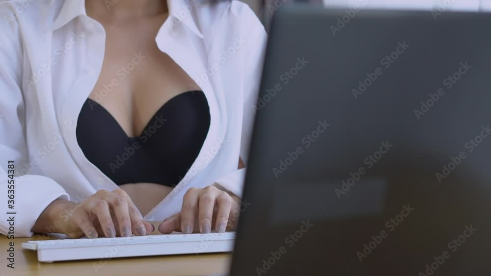 Closeup hand of young asian woman sexy in bra typing on keyboard computer, business woman is freelance work online to internet at home, social distracting, girl learning, lifestyle concept.