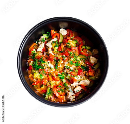 mouth-watering tasty vegetables red bell pepper carrots cucumber dill greens tomato onion shredded fried chicken meat in a pan together on a white background top view