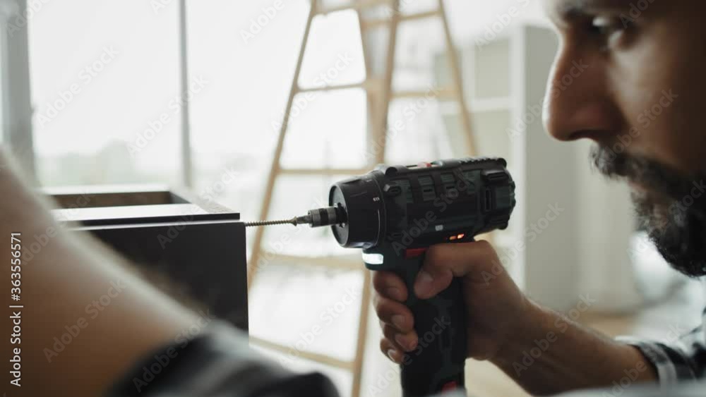 Close up video of carpenter using a cordless drill. Shot with RED helium camera in 8K Close up video of carpenter using a cordless drill. Shot with RED helium camera in 8K