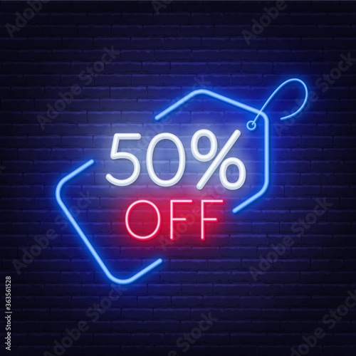 50 percent off neon sign on a dark background .
