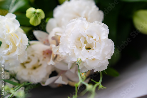 white lilies and carnations. top view of bouquets of fresh flowers.