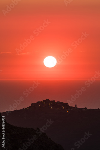 Sun setting over the village of Sant Antonino and Mediterranean