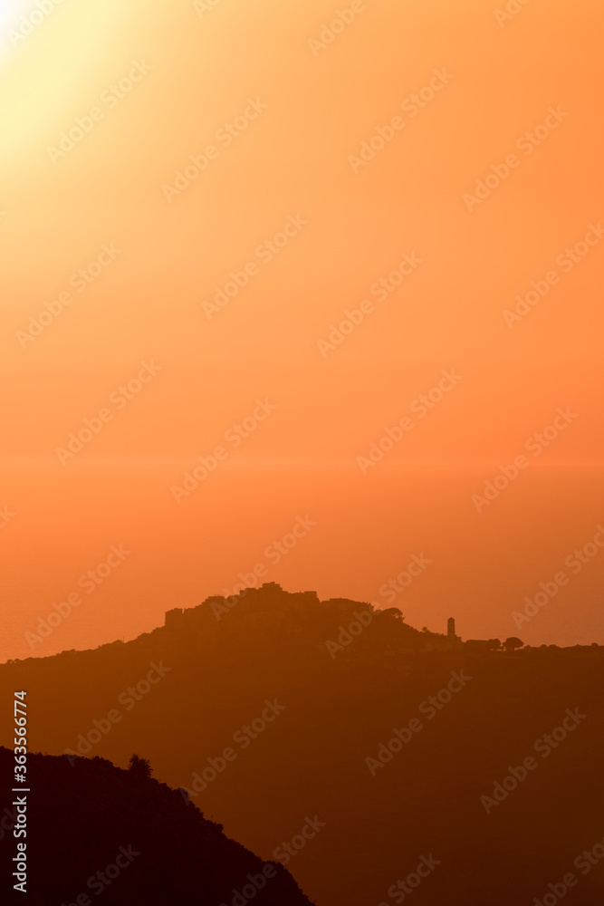 Evening sunlight on the village of Sant'Antonino and Mediterranean Evening sunlight on the village of Sant'Antonino and Mediterranean