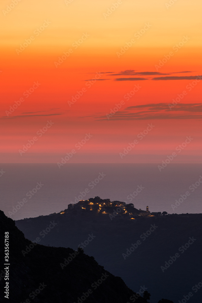Sun setting over the village of Sant'Antonino and Mediterranean