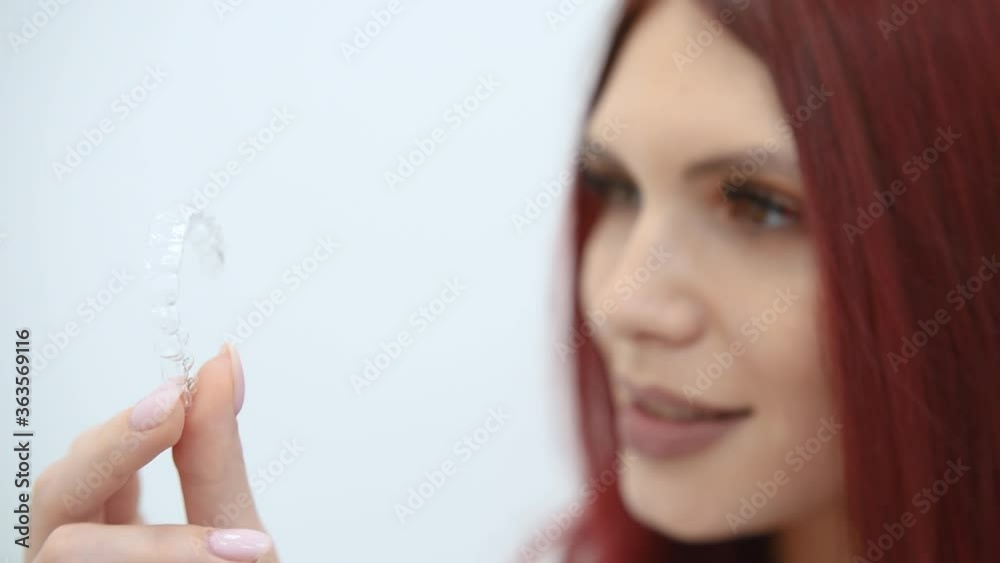 Woman with a beautiful smile shows a transparent mouth guard Woman with a beautiful smile shows a transparent mouth guard