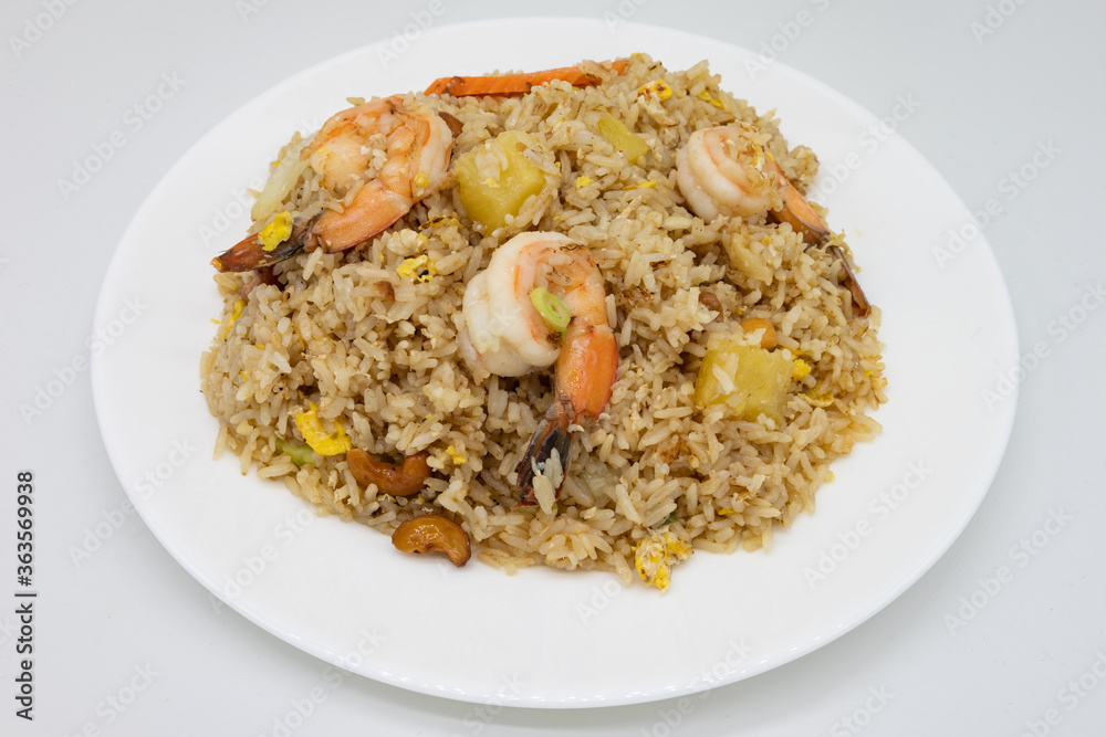 Thai Fried Rice with Shrimp and Pineapple on a White Plate Thai Fried Rice with Shrimp and Pineapple on a White Plate