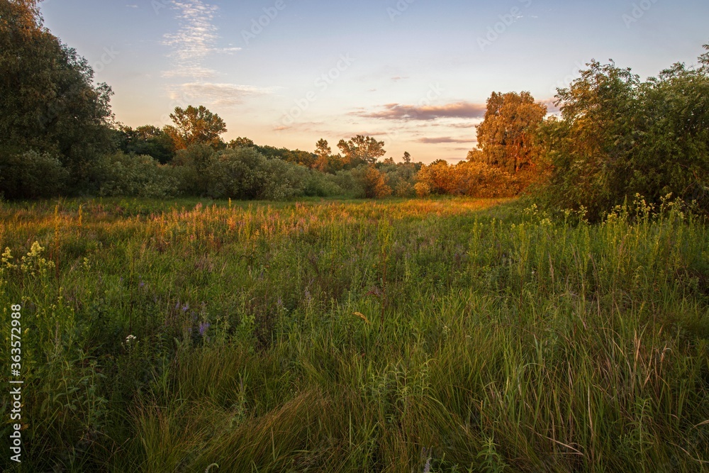 Sunset on a meadow over the river