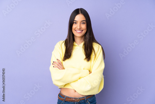 Fotografie Young caucasian woman over isolated background keeping the arms crossed in front
