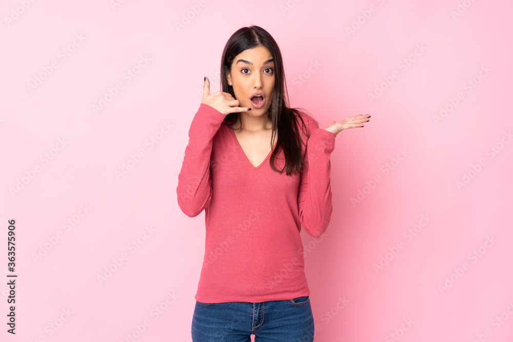 Young caucasian woman over isolated background making phone gesture and doubting Young caucasian woman over isolated background making phone gesture and doubting