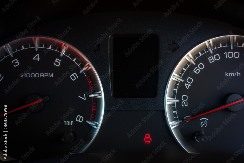 speedometer on black background in car