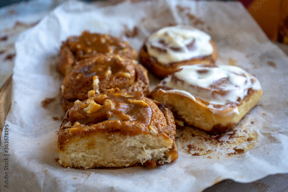 fresh baked homemade cinnamon rolls glazed with classic cream cheese and caramel, traditional cinnabons home baking