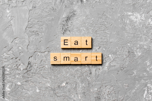 Eat smart word written on wood block. Eat smart text on cement table for your desing, Top view concept