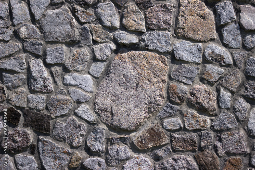 Stone wall, texture. Granite stones of different sizes, masonry. Background Stone wall, texture. Granite stones of different sizes, masonry. Background
