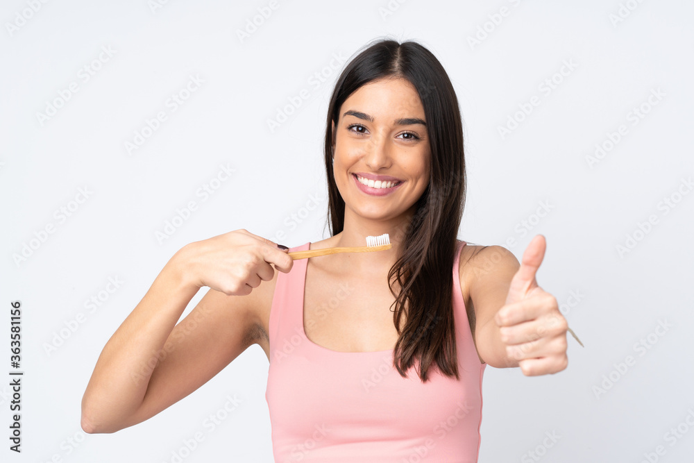Young caucasian woman isolated on white background with a toothbrush Young caucasian woman isolated on white background with a toothbrush