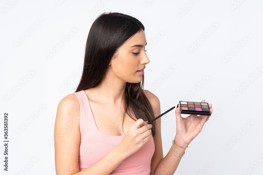 Young caucasian woman isolated on white background with makeup palette Young caucasian woman isolated on white background with makeup palette
