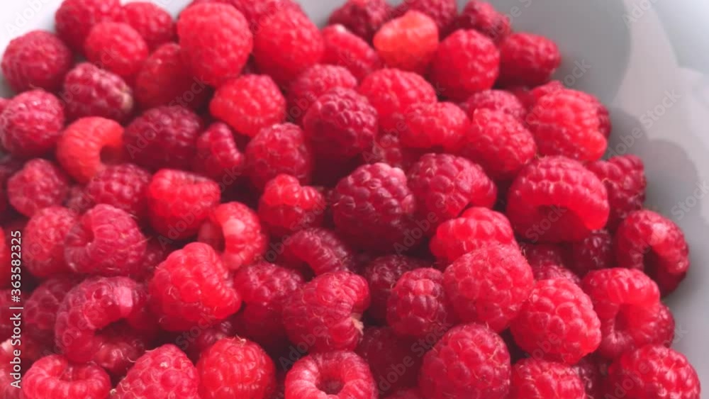 Juicy fresh raspberries with water drops in motion. beautiful bokeh Juicy fresh raspberries with water drops in motion. beautiful bokeh