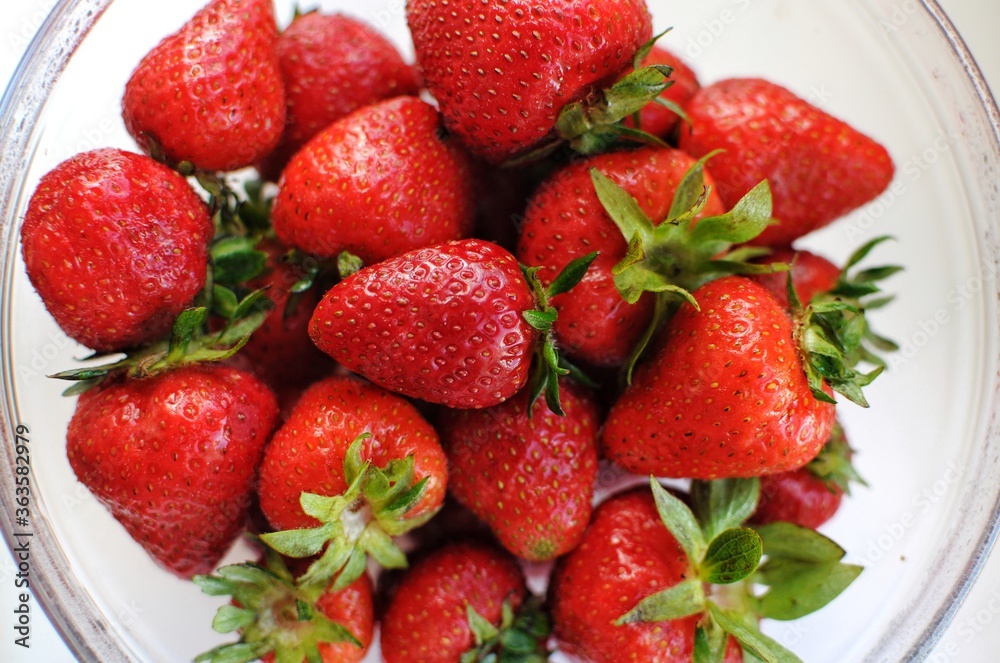 Home strawberry close up background. Summer vitamin fruits in transparent bowl. Home strawberry close up background. Summer vitamin fruits in transparent bowl.