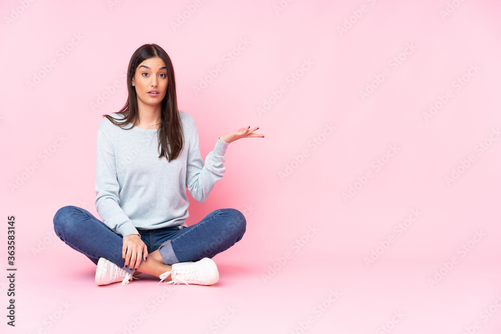 Young caucasian woman isolated on pink background making doubts gesture Young caucasian woman isolated on pink background making doubts gesture