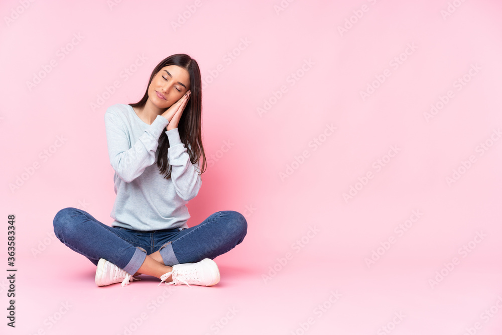 Young caucasian woman isolated on pink background making sleep gesture in dorable expression Young caucasian woman isolated on pink background making sleep gesture in dorable expression