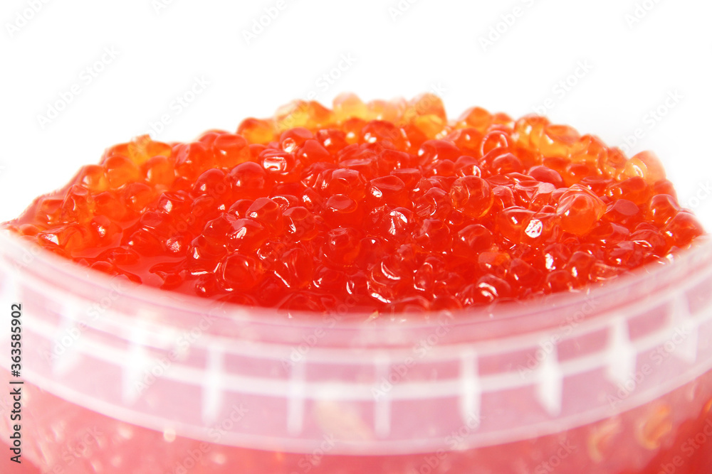 Red caviar in a plastic container on a white background. Caviar storage. Seafood. Expensive food Red caviar in a plastic container on a white background. Caviar storage. Seafood. Expensive food