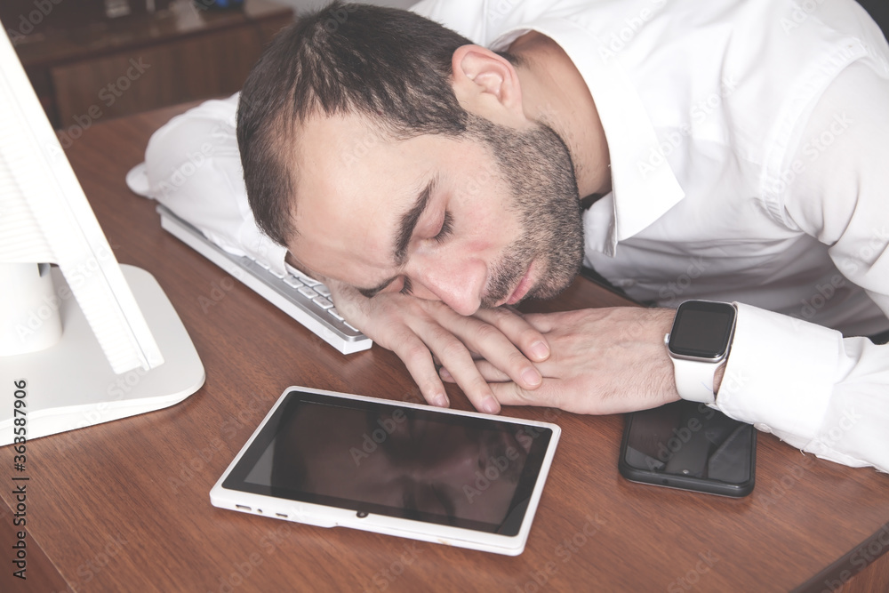 Man sleeping over working place in office. Man sleeping over working place in office.