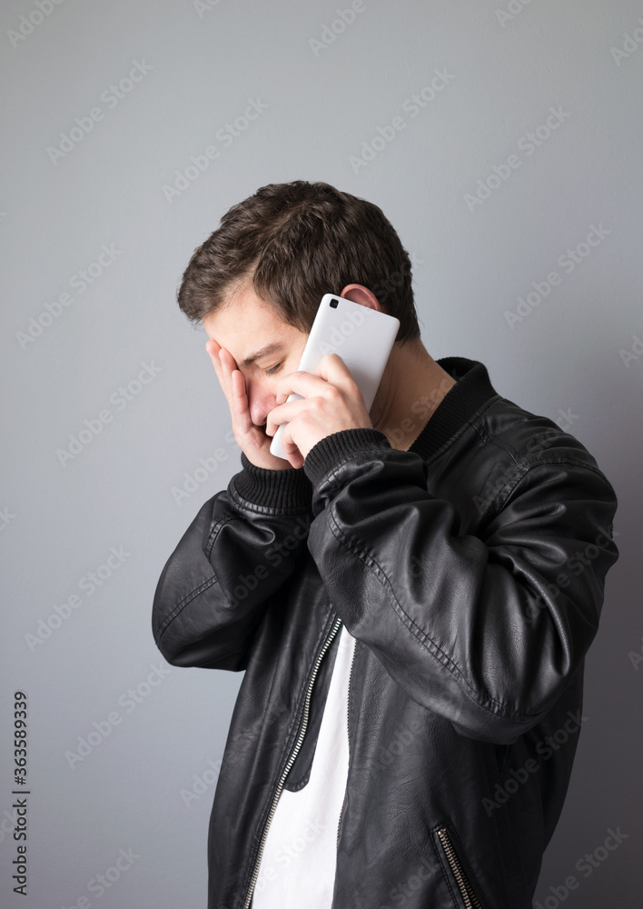 Teenager talking on mobile phone with a gesture of concern Teenager talking on mobile phone with a gesture of concern