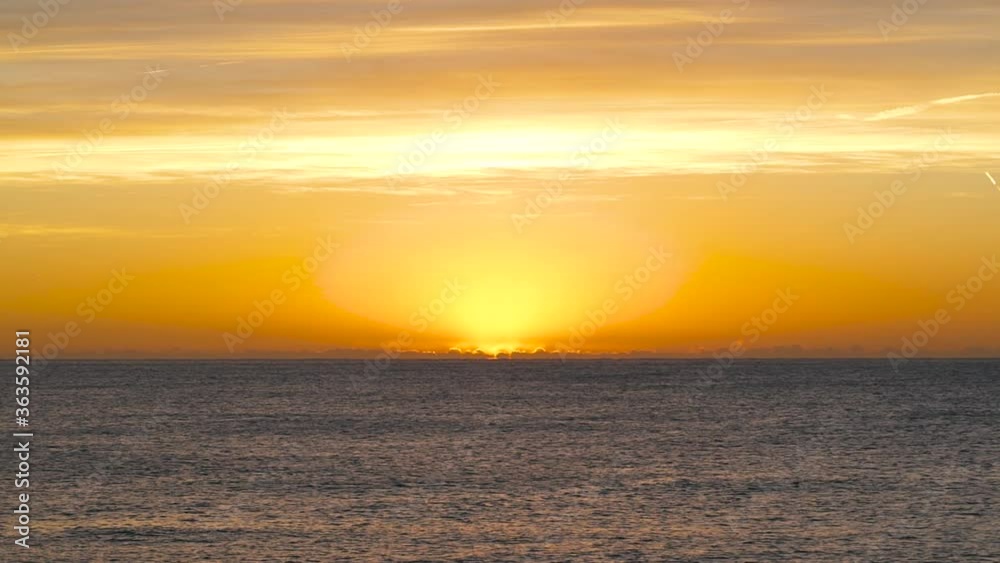 The sun appearing behind the horizon of the sea on the spanish coast. The sun appearing behind the horizon of the sea on the spanish coast.