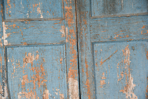 Background old cabinet door with falling blue paint.